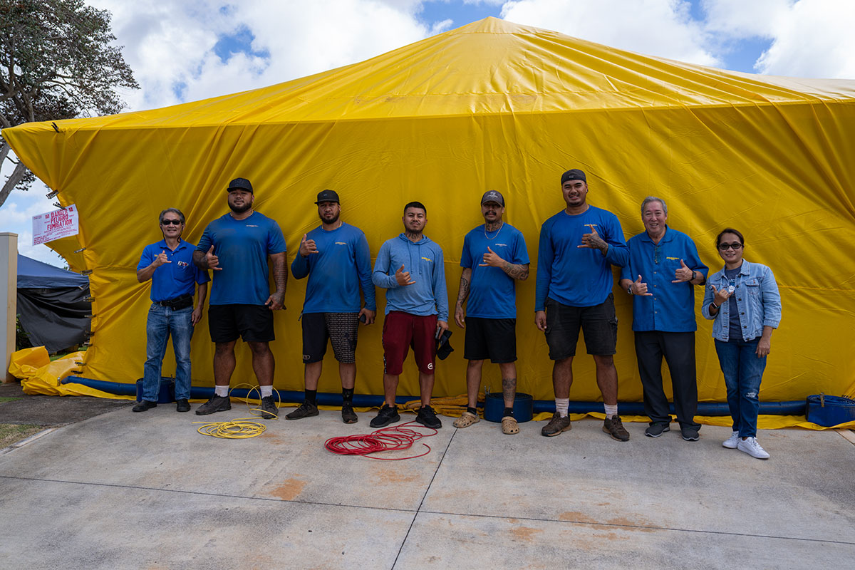 Xtermco termite fumigation crew standing in front of a tented home on Oʻahu